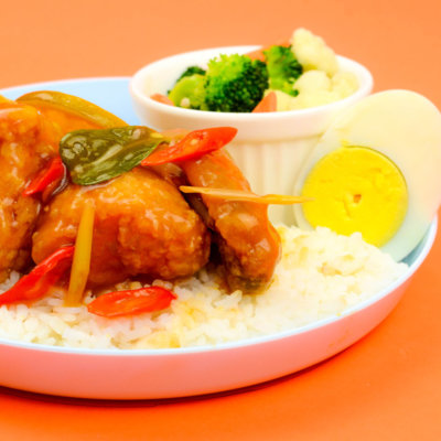 Image of tasty Thai Chicken Sauce served with hard-boiled egg and fresh vegetables as side dish
