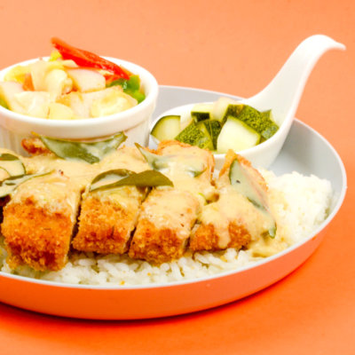 Image of luscious Creamy-Salted Egg Yolk Chicken chop served with rice and pickled radish