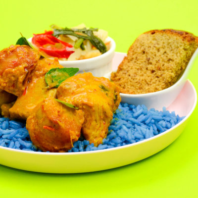 Image of delicious Signature Kapitan Curry Chicken with butterfly pea rice and egg