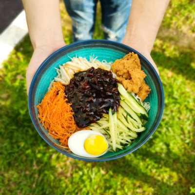 Image of flavory Soy-bean paste noodles served with Chicken Katsu and hard-boiled egg